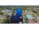 Aerial view of a canal with waterfront properties and lush landscaping at 9567 Honeymoon Dr, Port Charlotte, FL 33981