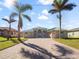 One-story home with green metal roof and paver driveway at 9567 Honeymoon Dr, Port Charlotte, FL 33981