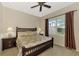 Spacious bedroom with ceiling fan, large window, and a dresser at 13241 Creekside Ln, Port Charlotte, FL 33953