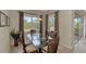 Bright dining area with glass-top table and comfortable seating for six at 13241 Creekside Ln, Port Charlotte, FL 33953