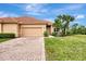 Tan single story home with tile roof and attached garage at 13241 Creekside Ln, Port Charlotte, FL 33953