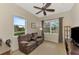 Home office with brown leather couch, built in shelving and large window at 13241 Creekside Ln, Port Charlotte, FL 33953