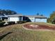 Blue house with a well-maintained lawn and driveway at 1329 Sheehan Blvd, Port Charlotte, FL 33952