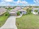 Single-Gathering home with a large yard, driveway, and two-car garage at 171 Medalist Rd, Rotonda West, FL 33947