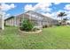 Screened pool and patio area with lush landscaping at 171 Medalist Rd, Rotonda West, FL 33947