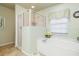 Soaking tub, shower, and neutral color palette at 171 Medalist Rd, Rotonda West, FL 33947