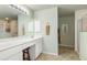 Double vanity, large mirror, and separate shower at 171 Medalist Rd, Rotonda West, FL 33947