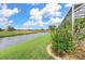 Peaceful backyard view of canal and lush landscaping at 171 Medalist Rd, Rotonda West, FL 33947