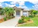 Landscaped front yard with walkway to entryway at 171 Medalist Rd, Rotonda West, FL 33947