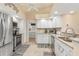 White kitchen with stainless steel appliances and granite countertops at 171 Medalist Rd, Rotonda West, FL 33947