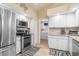 White kitchen with stainless steel appliances and granite countertops at 171 Medalist Rd, Rotonda West, FL 33947