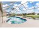 Inviting kidney-shaped pool with screened enclosure at 171 Medalist Rd, Rotonda West, FL 33947