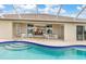 Screened pool area with view into the home at 171 Medalist Rd, Rotonda West, FL 33947