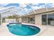 Relaxing kidney-shaped pool with screened enclosure at 171 Medalist Rd, Rotonda West, FL 33947