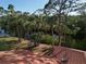 Aerial view of canal-front property with lush landscaping at 2397 Cannolot Blvd, Port Charlotte, FL 33948