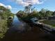 Aerial view of canal with boat docks and lush vegetation at 2397 Cannolot Blvd, Port Charlotte, FL 33948