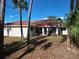 Single-story home with terracotta tile roof and palm trees at 2397 Cannolot Blvd, Port Charlotte, FL 33948