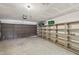 Garage with storage shelving and an open garage door at 2397 Cannolot Blvd, Port Charlotte, FL 33948