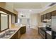 Galley kitchen with dark wood cabinets and stainless steel appliances at 2397 Cannolot Blvd, Port Charlotte, FL 33948