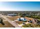 Aerial view of a house and surrounding neighborhood with a lake at 409 Boundary Blvd, Rotonda West, FL 33947