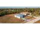 Aerial view of a light blue house with large lot and surrounding neighborhood at 409 Boundary Blvd, Rotonda West, FL 33947