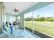 Relaxing screened porch with seating area overlooking a grassy backyard at 409 Boundary Blvd, Rotonda West, FL 33947