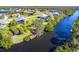 Aerial view of waterfront property with private dock and lush landscaping at 4678 Arlington Dr, Placida, FL 33946