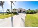 Single-story house with palm trees, a driveway, and a screened entrance at 4678 Arlington Dr, Placida, FL 33946