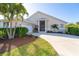 Single-story home with a screened porch, landscaped yard, and two-car garage at 4678 Arlington Dr, Placida, FL 33946