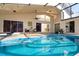 Relaxing pool area with covered patio, seating, and views of the surrounding landscape at 4678 Arlington Dr, Placida, FL 33946