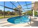 Enclosed pool and patio area with plenty of seating and a view of palm trees at 4678 Arlington Dr, Placida, FL 33946