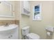 Clean bathroom with white vanity, toilet, and a window at 537 Shamrock Blvd, Venice, FL 34293