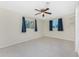 Bright bedroom with two windows, ceiling fan, and neutral walls at 537 Shamrock Blvd, Venice, FL 34293