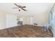 Spacious living room with wood-look floors and access to sunroom at 537 Shamrock Blvd, Venice, FL 34293