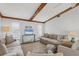 Relaxing living room featuring neutral decor and exposed beams at 560 Sandlor Dr, Englewood, FL 34223