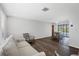 Living room with hardwood floors, neutral walls, and comfortable seating at 560 Sandlor Dr, Englewood, FL 34223