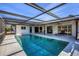 Inviting pool area with covered patio and screened enclosure at 560 Sandlor Dr, Englewood, FL 34223