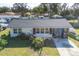 Single-story home with a dark roof, dolphin mural, and a grassy yard at 135 W Langsner St, Englewood, FL 34223