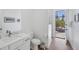 Bathroom with toilet and access to patio at 15625 Melport Cir, Port Charlotte, FL 33981