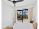 Bedroom with sliding doors to patio at 15625 Melport Cir, Port Charlotte, FL 33981