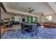 Spacious covered patio with outdoor furniture and ceiling fans, adjacent to living area at 15625 Melport Cir, Port Charlotte, FL 33981