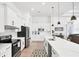 Modern kitchen with white cabinets, quartz countertops, and stainless steel appliances at 15625 Melport Cir, Port Charlotte, FL 33981