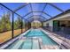 Inviting pool and spa with screened enclosure, perfect for relaxation at 15625 Melport Cir, Port Charlotte, FL 33981