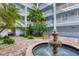 Tranquil courtyard featuring a water fountain and tropical landscaping at 2001 Bal Harbor Blvd # 2203, Punta Gorda, FL 33950