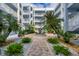 Lush courtyard with fountain, brick walkways, and tropical plants at 2001 Bal Harbor Blvd # 2203, Punta Gorda, FL 33950