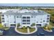 Exterior view of a light blue condo building with parking and landscaping at 2001 Bal Harbor Blvd # 2203, Punta Gorda, FL 33950