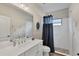 Modern bathroom with a white vanity, a walk-in shower, and pebble flooring at 26812 Pavin Dr, Englewood, FL 34223