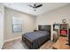 Bedroom with a dark-wood bed frame, built-in shelving, and a workspace at 26812 Pavin Dr, Englewood, FL 34223