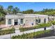 Community clubhouse with patio seating and surrounding landscaping at 26812 Pavin Dr, Englewood, FL 34223