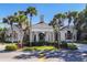 Community clubhouse with attractive landscaping and a grand entrance at 26812 Pavin Dr, Englewood, FL 34223